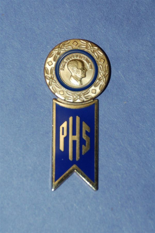 A Paul Harris Fellow pin with a Paul Harris Society hanger